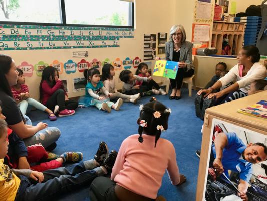 Congresswoman Clark reads a story book to children.