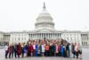 Women In Congress Leadership pose for a picture in front of the Capitol.