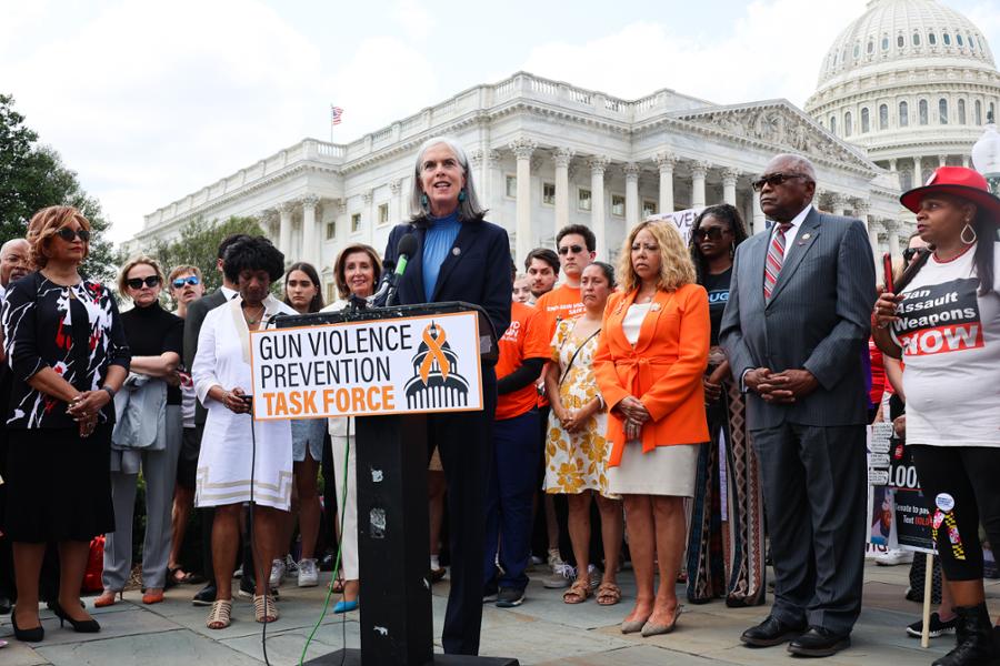 Rep. Clark speaks at a podium in front of the U.S. Capitol building. The podium sign says Gun Violence Task Force.