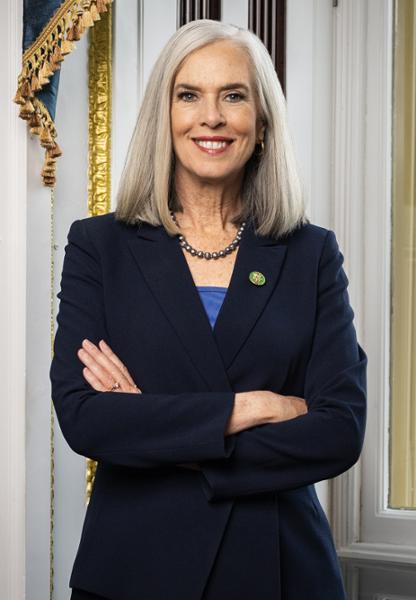 Congresswoman Clark's official portrait. She is smiling with her arms crossed, and is wearing a navy blue outfit.