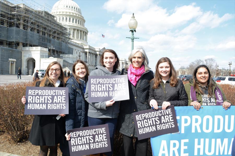 Rep. Clark poses for a pictue in front of the U.S. Capitol with reproductive freedom activists.