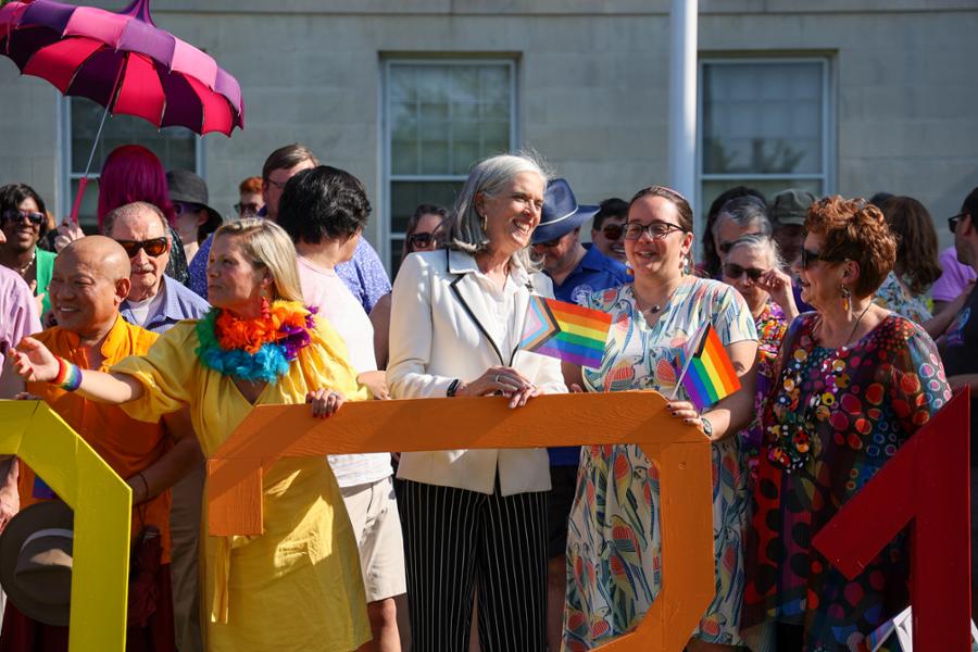Rep. Clark laughs with constituents outside of Medford City Hall during the city's annual Pride event.