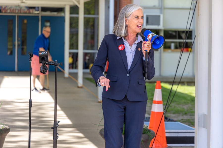 Rep. Clark speaks into a megaphone outside of a Framingham school at a rally to improve gun safety laws.